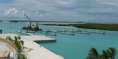 Crane barge driving piles during construction of the marina