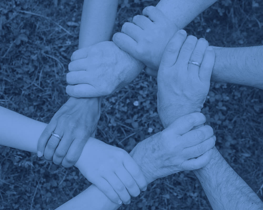Hands joined in a circle — Sagoma's partnerships across the island communities